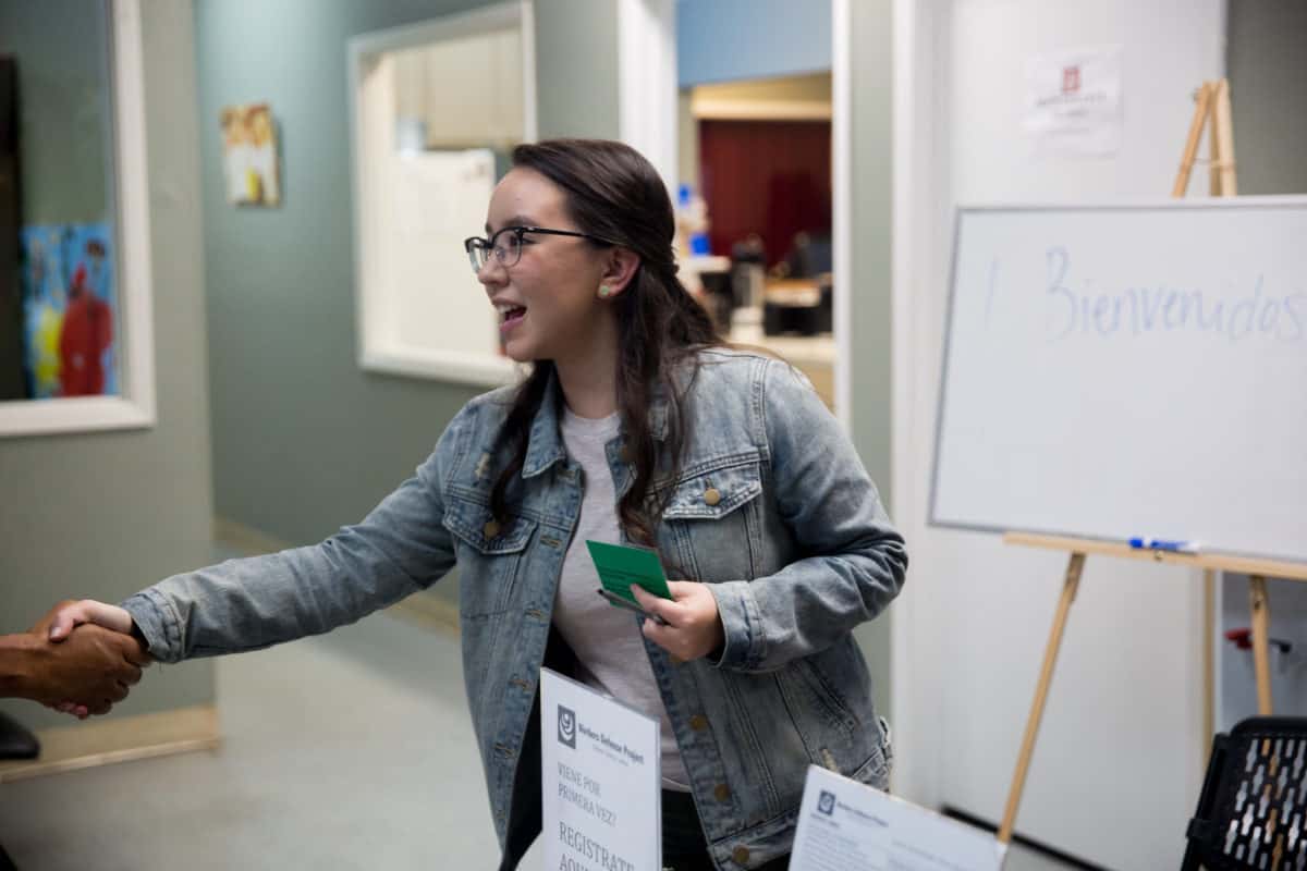 student in internship greeting a client