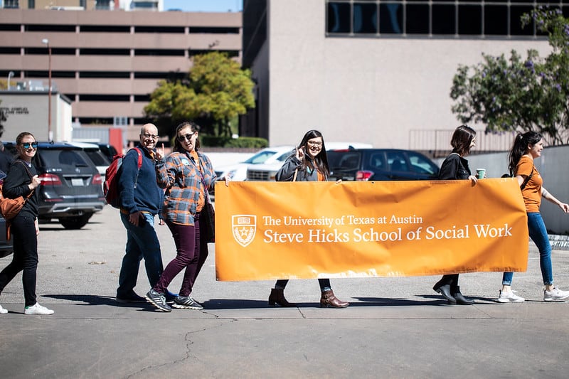students with Steve Hicks sign