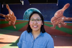 Cassandra Najera in front of one of East Austin's many murals. Photo by Shelby Knowles.