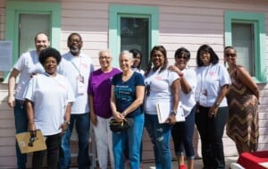 Rountree (far right) and CHE volunteers in front of the pink house