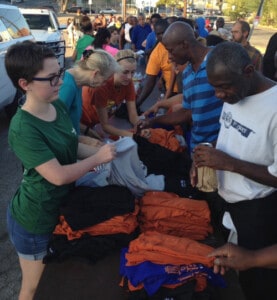 Students hand out shoes and clothing in downtown Austin