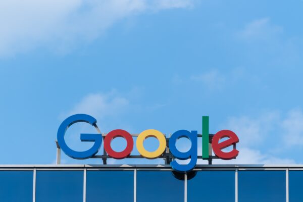 The Google logo against a bright blue sky.