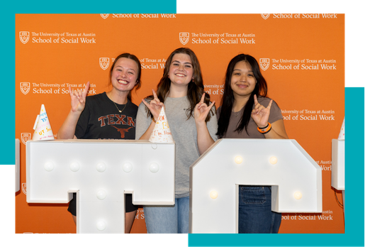 students in front of SSW picture backdrop